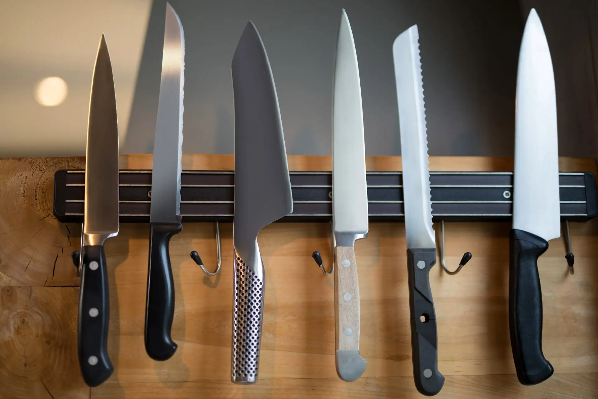 Set of sharp kitchen knives hanging on a wall Sharper Focus Ltd Bristol